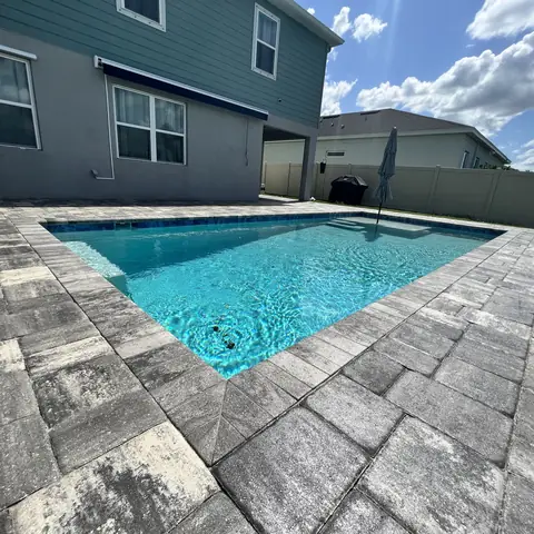 Sealed paver pool deck around a rectangular pool