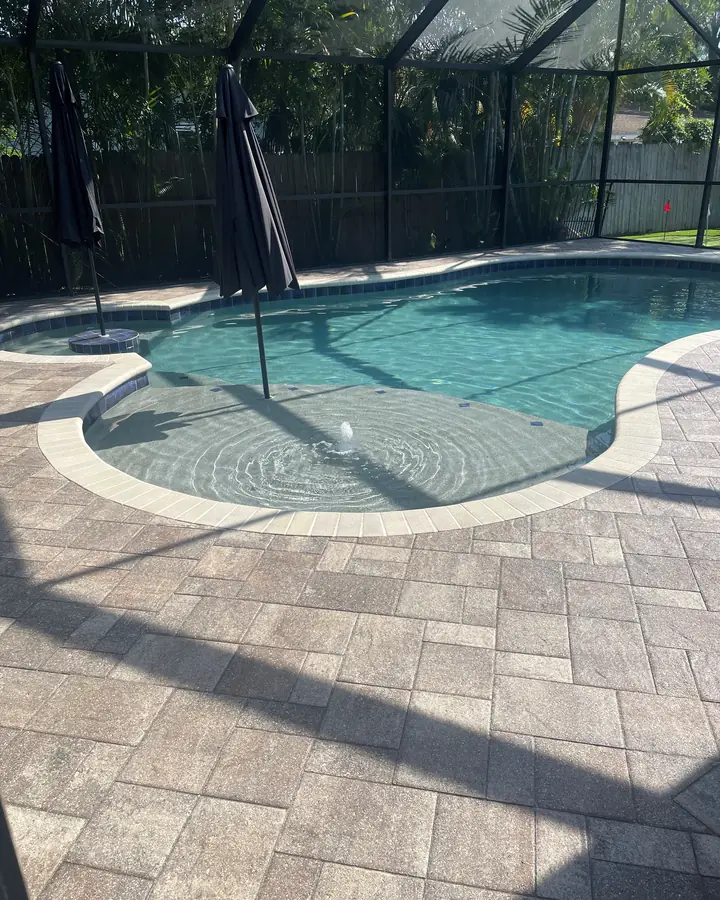 Sealed paver pool deck inside a screened lanai